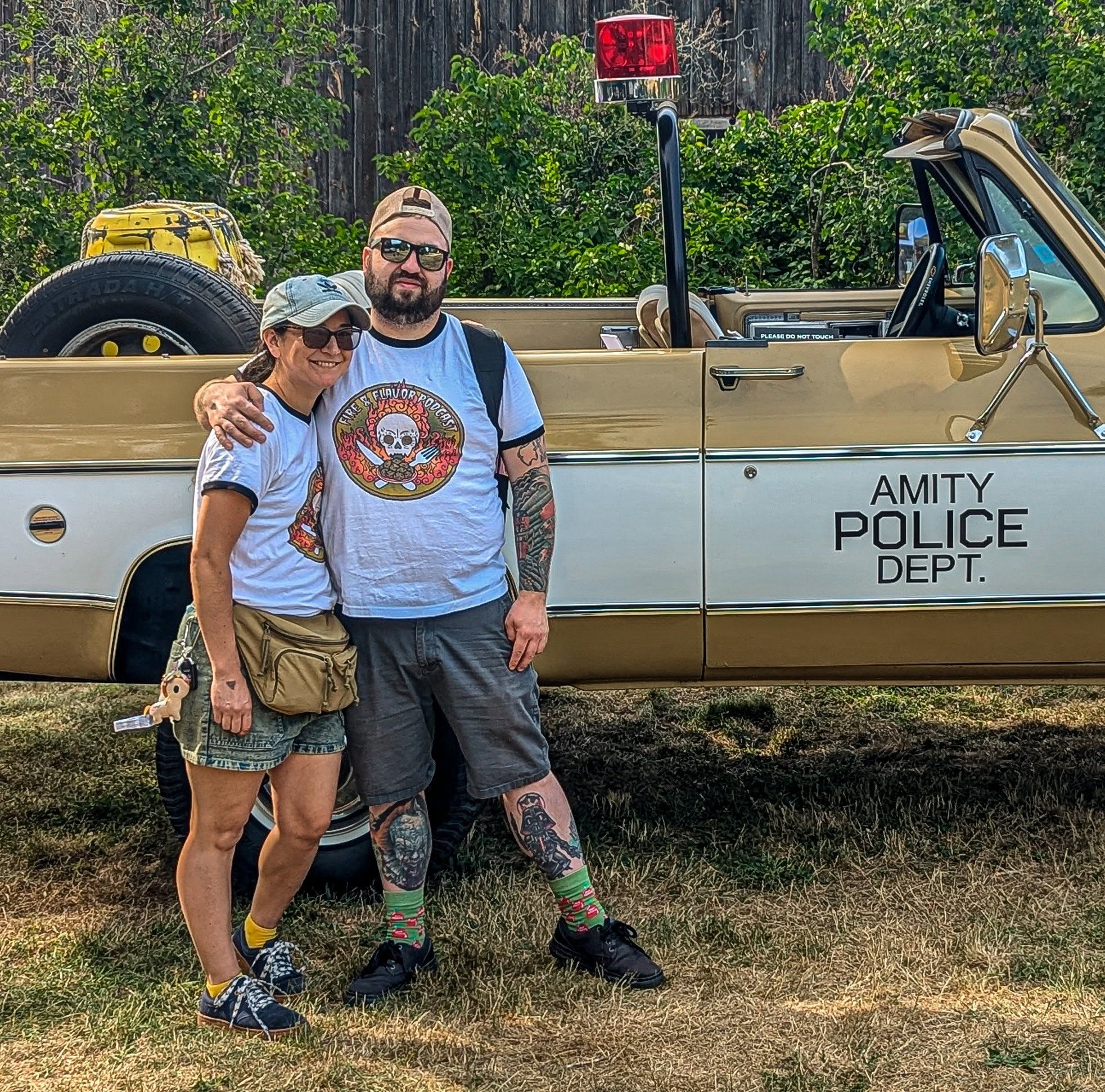 Matt Dahl standing beside another person in front of a themed vehicle